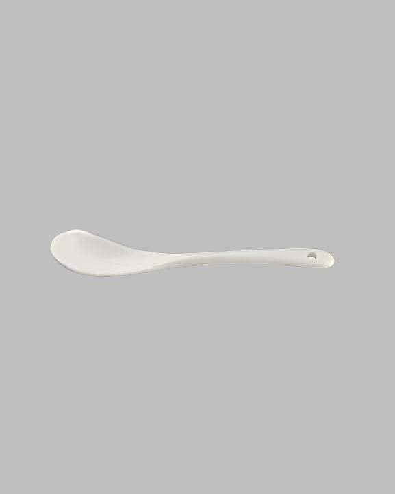 A single white ceramic spoon with a smooth finish, designed for kitchen use.