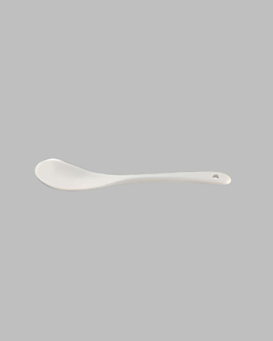 A single white ceramic spoon with a smooth finish, designed for kitchen use.